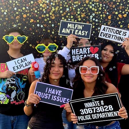 A wide selection of fun accessories and signs displayed for Backdrop Rentals for birthday party in Aurora, Illinois, organized by Mae Photo Booths LLC to enhance the guest experience.