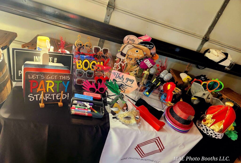 Premium Photo Booth Birthday Party Props and setup by Mae Photo Booths LLC, including a luxury red carpet, velvet rope stanchions, and an elegant floral arch backdrop for an Illinois birthday celebration.